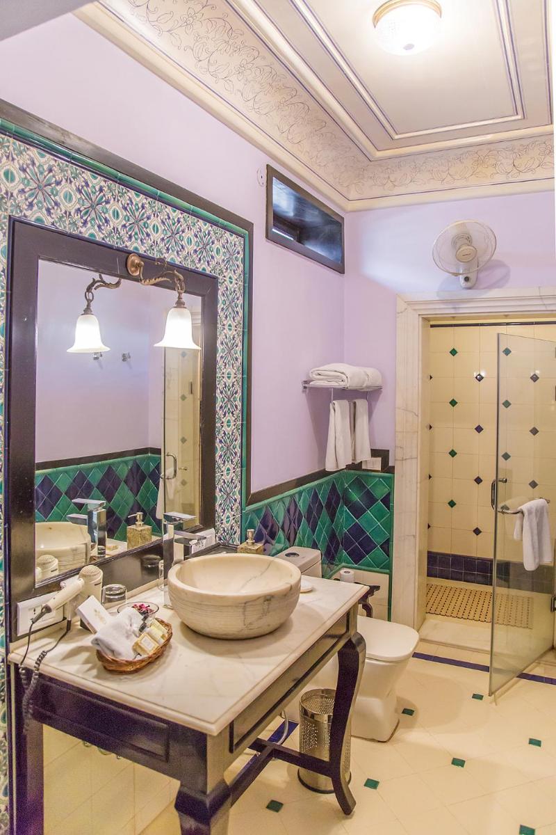 a bathroom with a sink and a toilet and a mirror at Royal Heritage Haveli - By Leisure Hotels in Jaipur