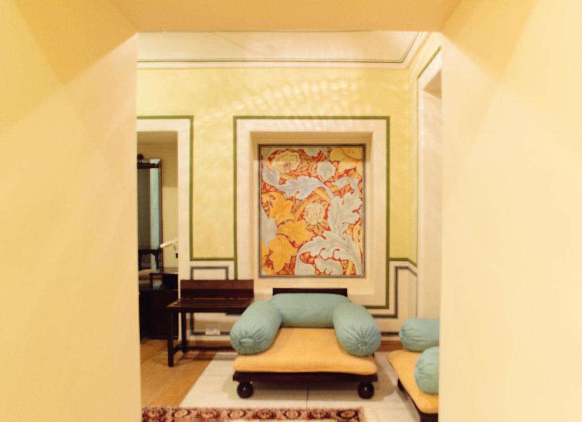 a room with a chair and a painting on the wall at Royal Heritage Haveli - By Leisure Hotels in Jaipur