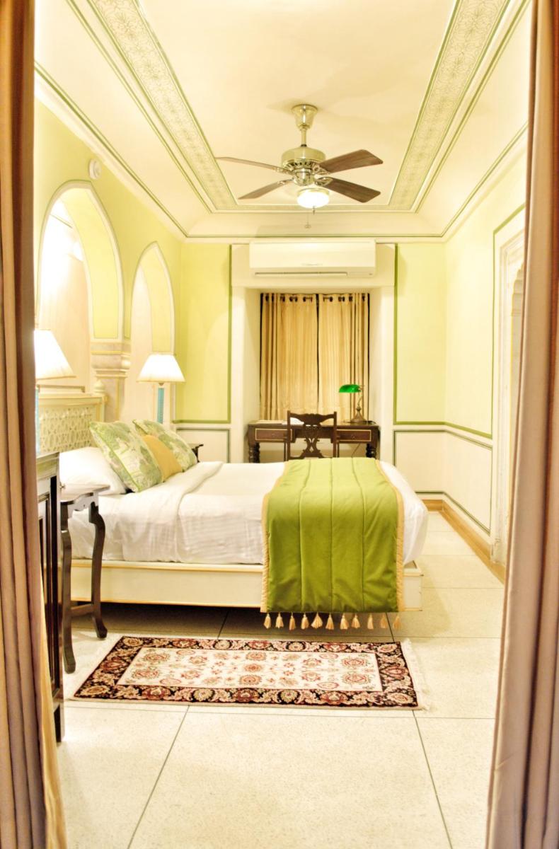 a bedroom with a bed and a ceiling fan at Royal Heritage Haveli - By Leisure Hotels in Jaipur