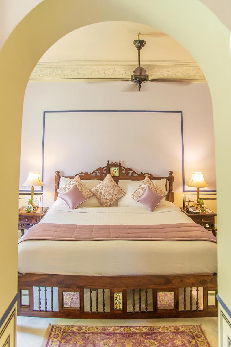 a bedroom with a large bed with pillows on it at Royal Heritage Haveli - By Leisure Hotels in Jaipur