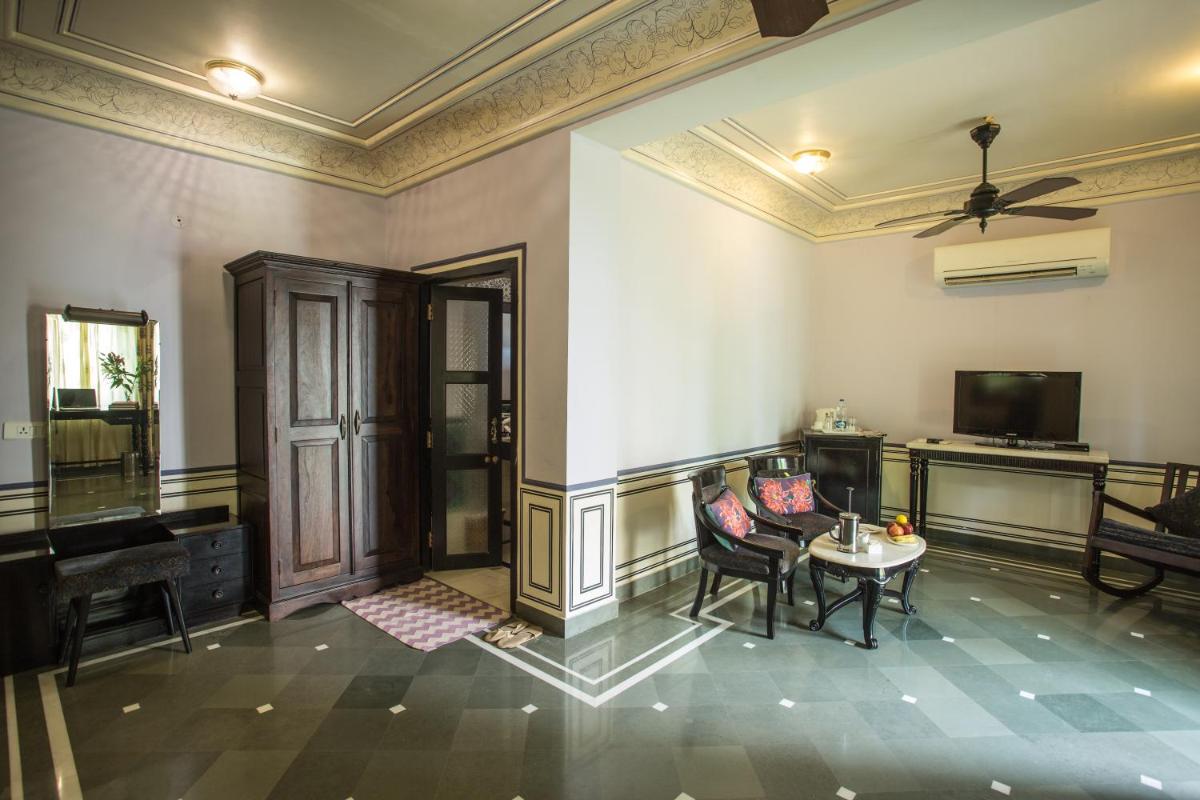 a room with a piano and a table and chairs at Royal Heritage Haveli - By Leisure Hotels in Jaipur