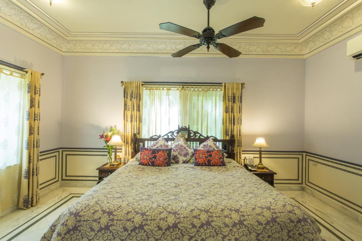 a bedroom with a bed with a ceiling fan at Royal Heritage Haveli - By Leisure Hotels in Jaipur