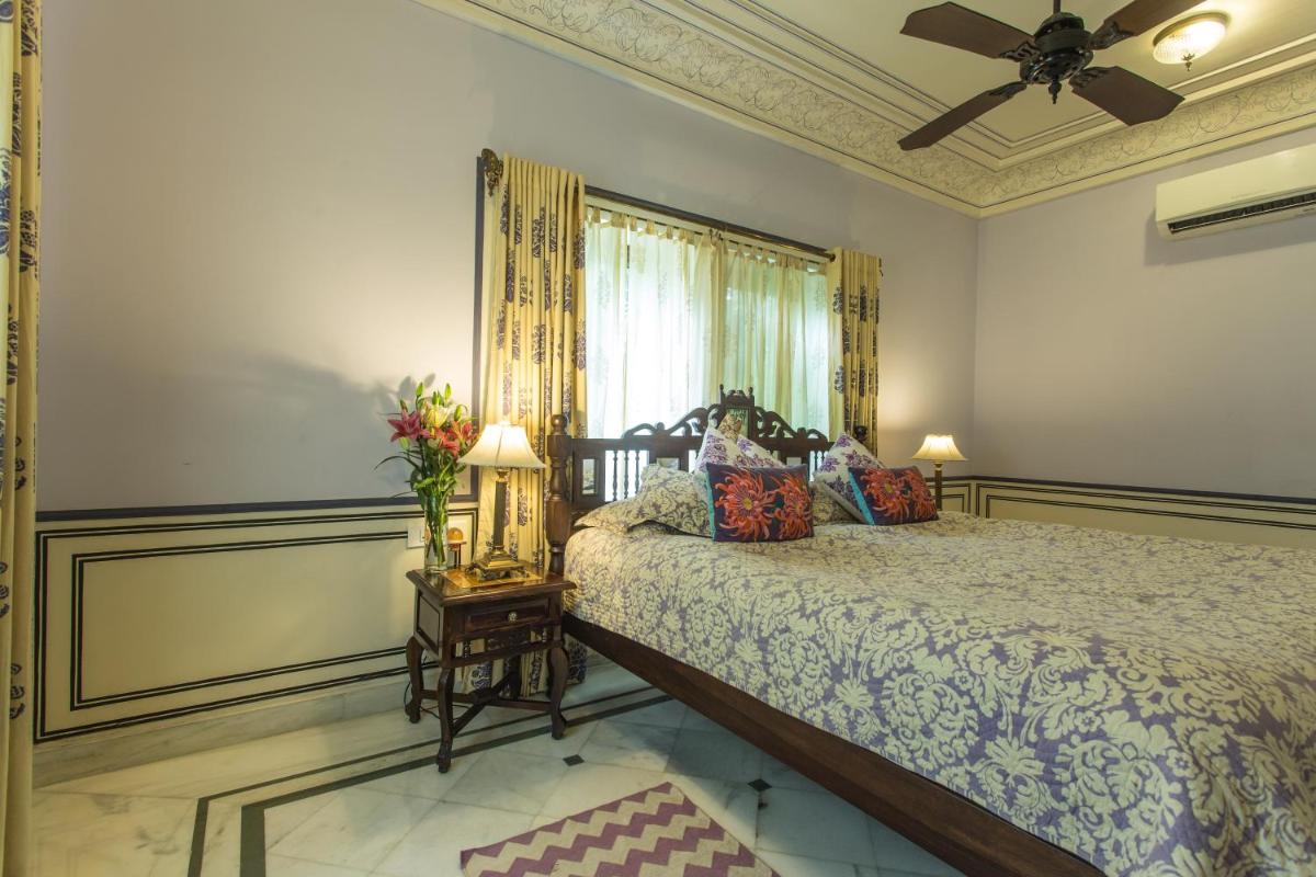 a bedroom with a bed and a ceiling fan at Royal Heritage Haveli - By Leisure Hotels in Jaipur