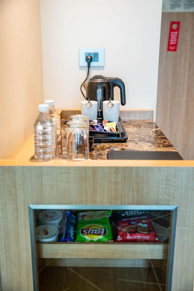 two pictures of a kitchen counter top with food at Holiday Inn Chennai OMR IT Expressway by IHG in Chennai