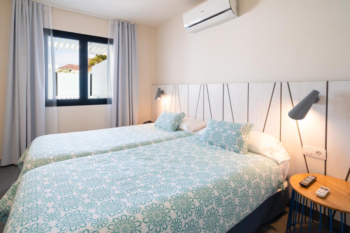 Cama o camas de una habitación en Relaxia Lanzasur Club - Aqualava Water Park