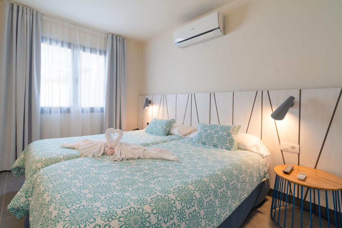 Cama o camas de una habitación en Relaxia Lanzasur Club - Aqualava Water Park