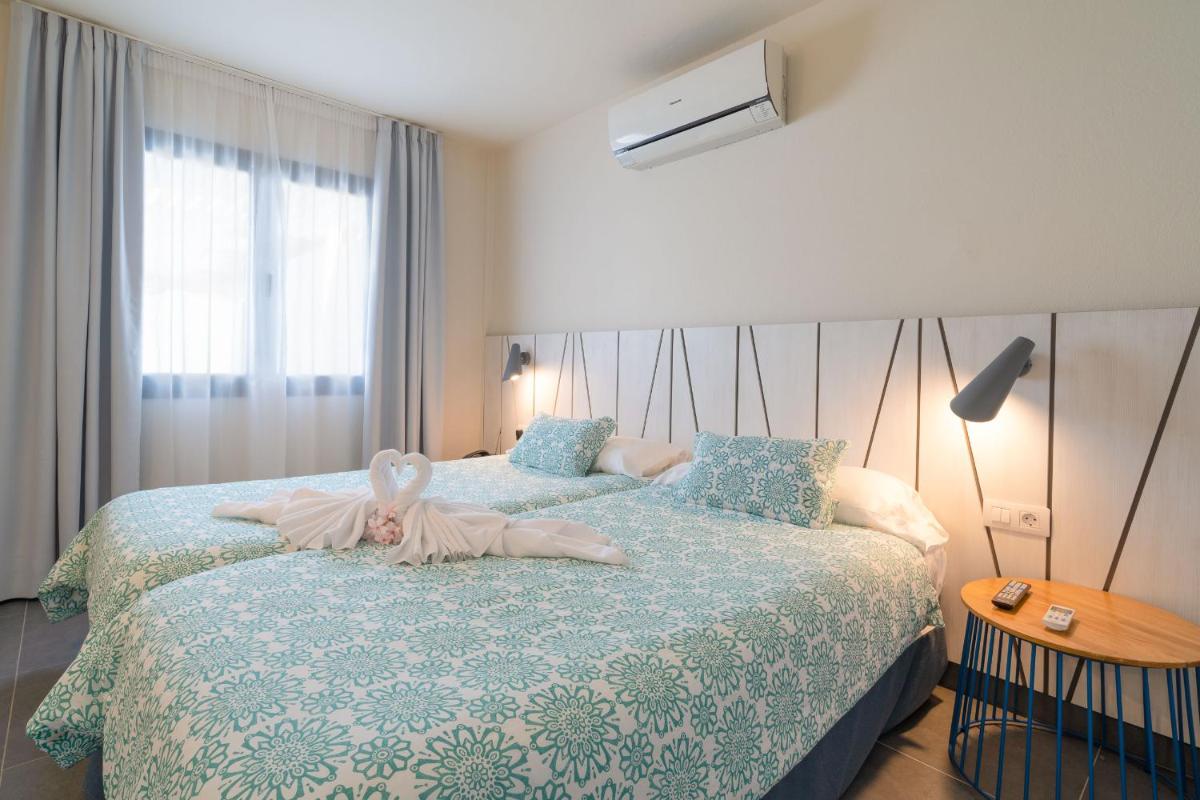 Cama o camas de una habitación en Relaxia Lanzasur Club - Aqualava Water Park