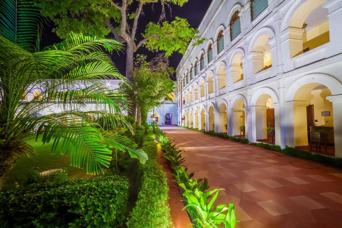 a courtyard of a building with trees and plants at The Grand Imperial - Heritage Hotel in Agra