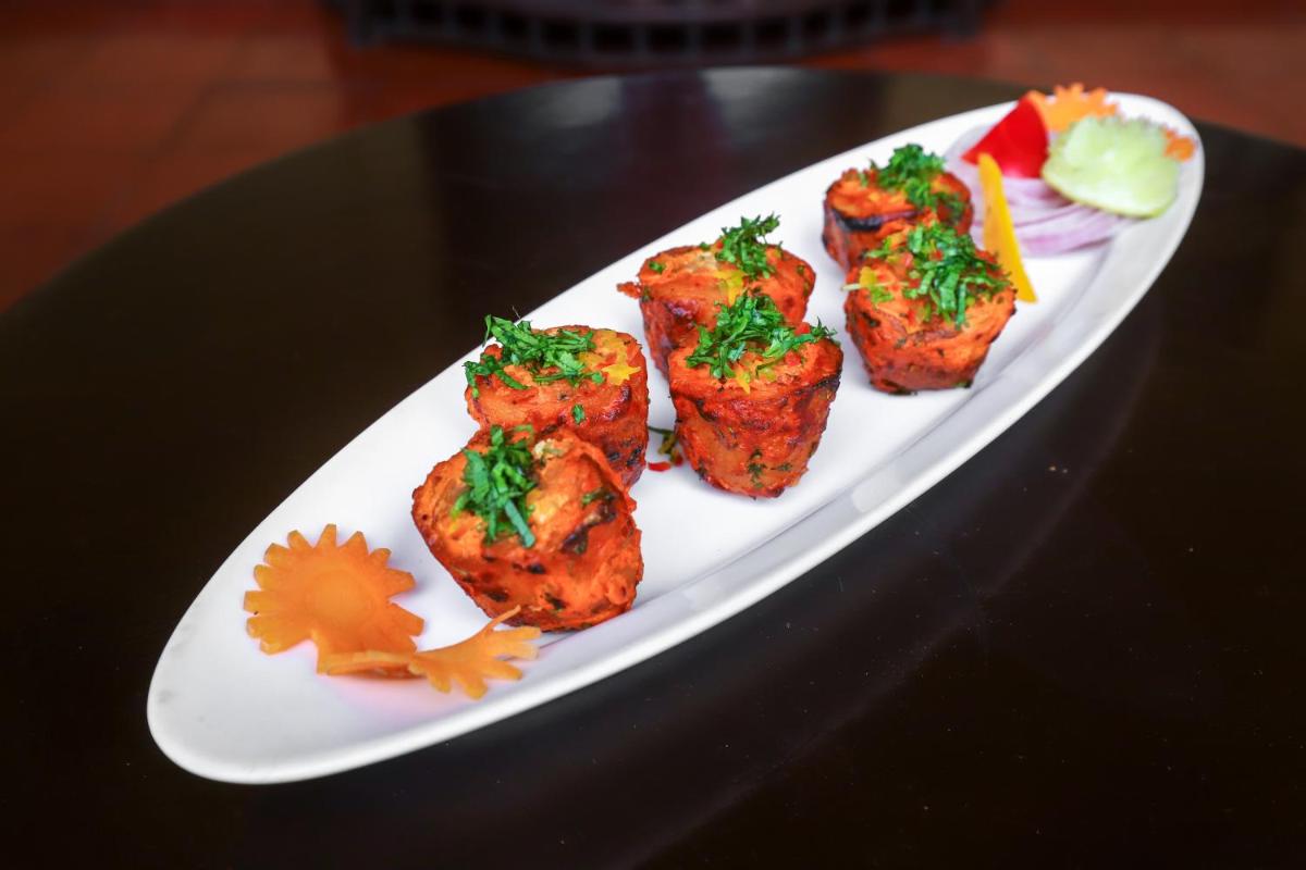 a white plate of food on a table at The Grand Imperial - Heritage Hotel in Agra