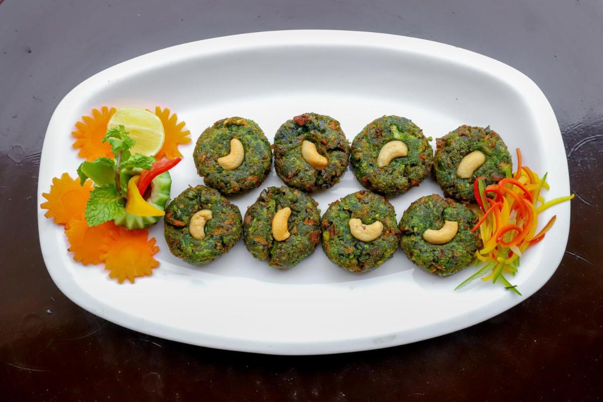 a white plate of food on a table at The Grand Imperial - Heritage Hotel in Agra