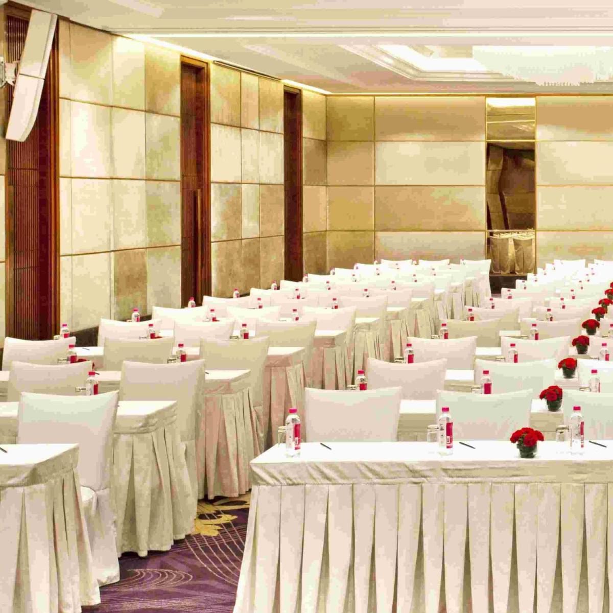 a banquet hall with white tables and chairs at Holiday Inn New Delhi Mayur Vihar Noida by IHG in New Delhi a banquet hall with white tables and chairs at Holiday Inn New Delhi Mayur Vihar Noida by IHG in New Delhi