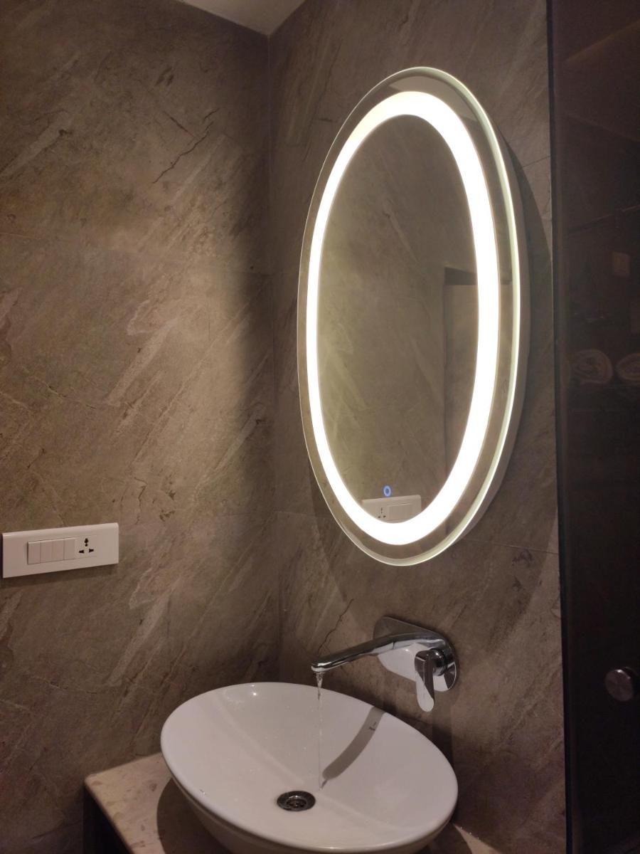 a bathroom with a sink and a mirror at Antalya By Divine Ganga Cottage in Rishīkesh
