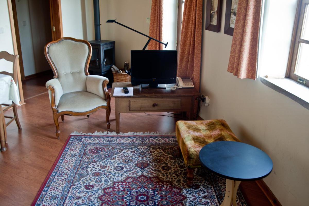 Uma televisão e/ou sistema de entretenimento em Hotel Rural Quinta da Geia