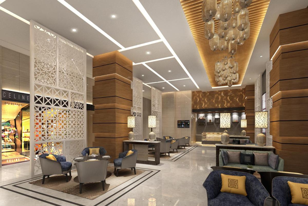 a lobby of a hotel with chairs and tables at Taj Skyline Ahmedabad in Ahmedabad