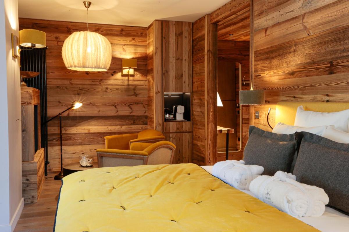 Un ou plusieurs lits dans un hébergement de l'établissement Hotel Le V de Vaujany