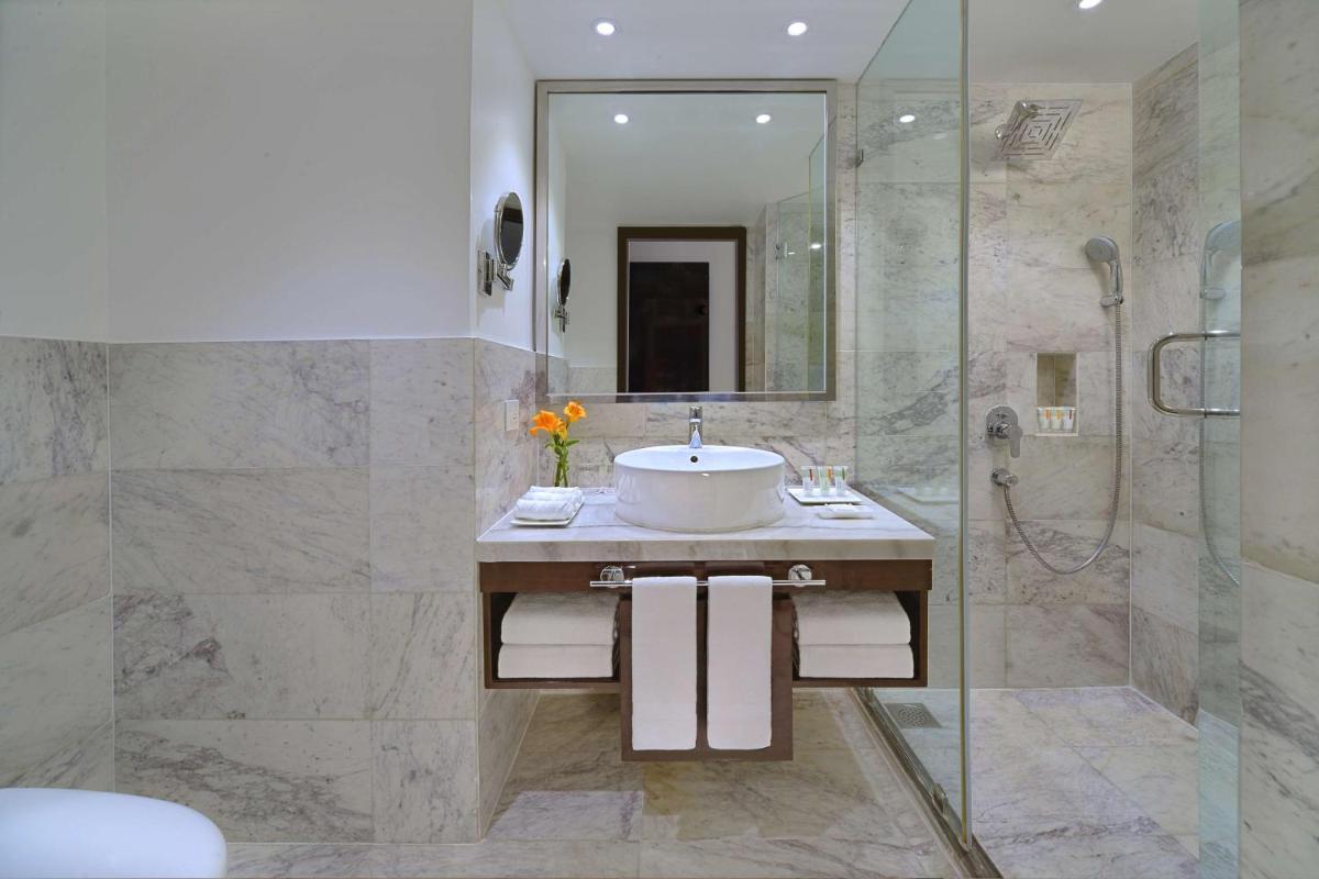 a bathroom with a sink and a shower at Radisson Hotel Agra in Agra