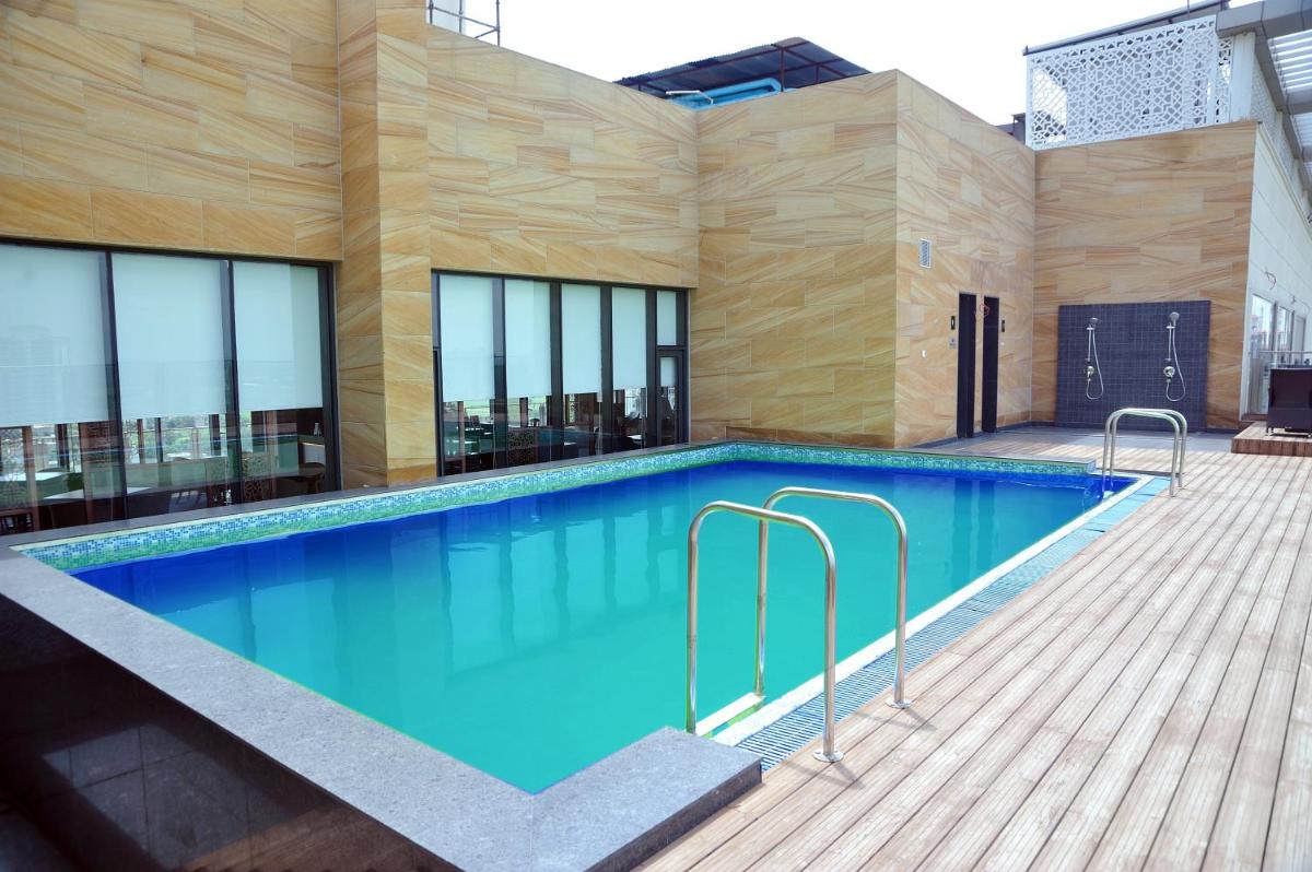 a swimming pool in the middle of a building at Holiday Inn Gurugram Sector 90 by IHG in Gurgaon