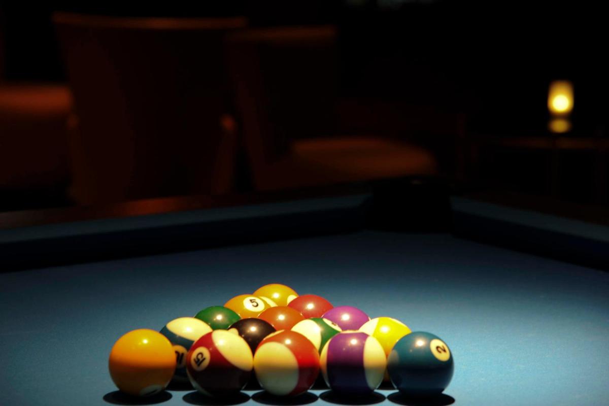 a group of billiard balls on a pool table at Gokulam Grand Hotel & Spa Bangalore in Bengaluru a group of billiard balls on a pool table at Gokulam Grand Hotel & Spa Bangalore in Bengaluru