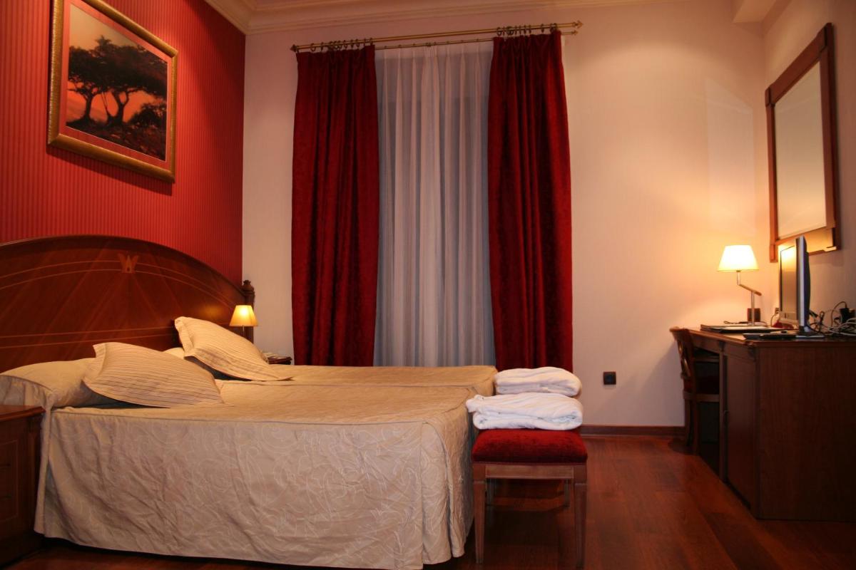 Cama o camas de una habitación en Hotel Palacio de la Magdalena