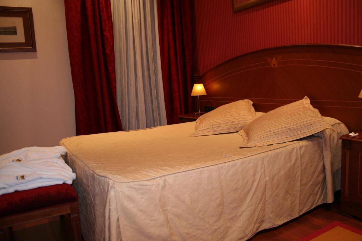 Cama o camas de una habitación en Hotel Palacio de la Magdalena