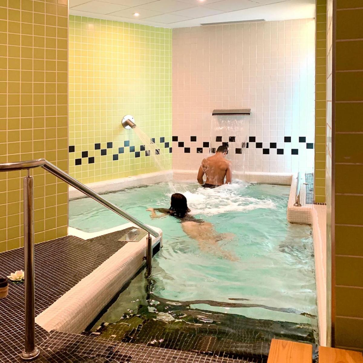 un hombre en una bañera con una persona en ella en Gran Hotel Don Manuel, en Cáceres
