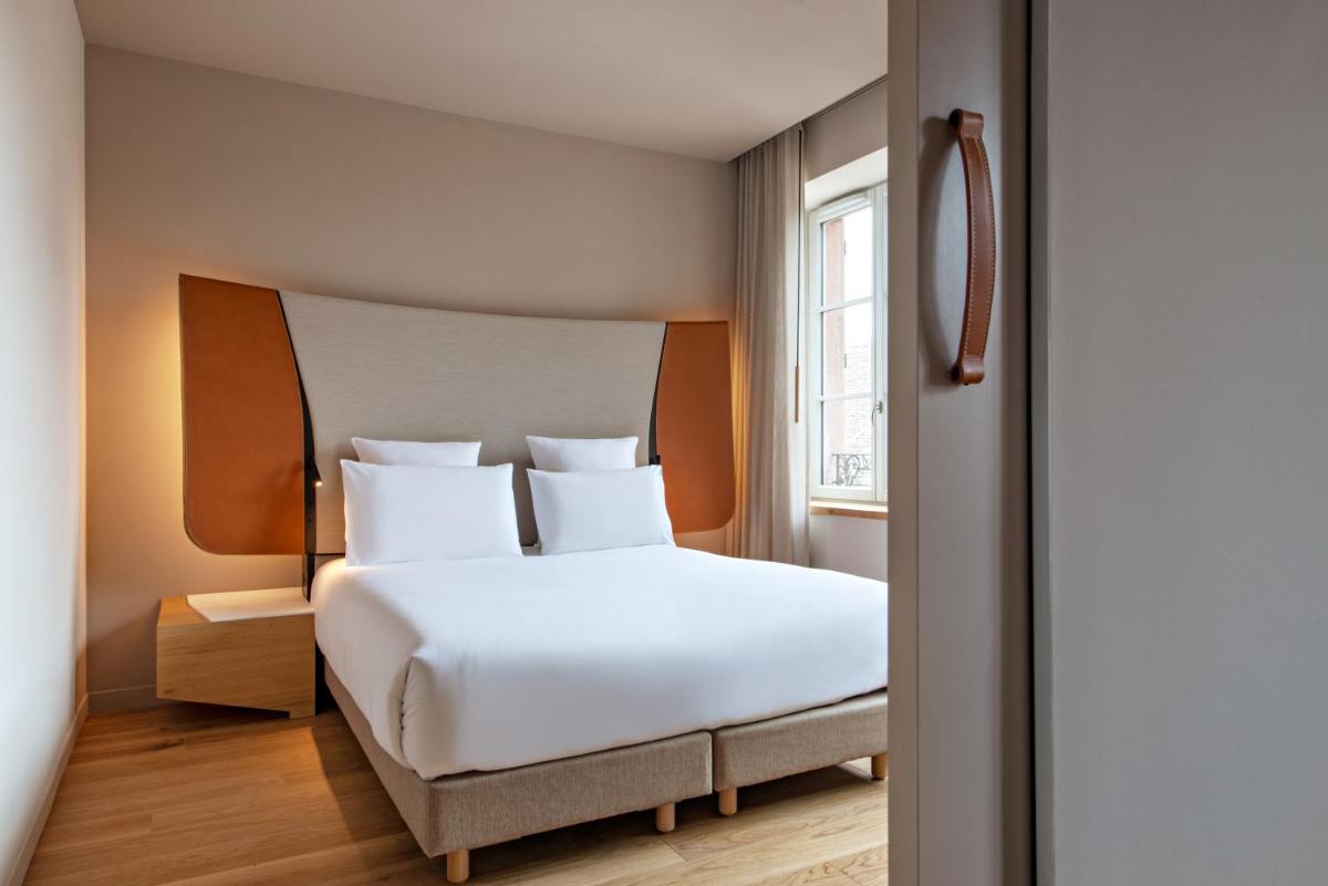 Un ou plusieurs lits dans un hébergement de l'établissement Hotel Les Haras