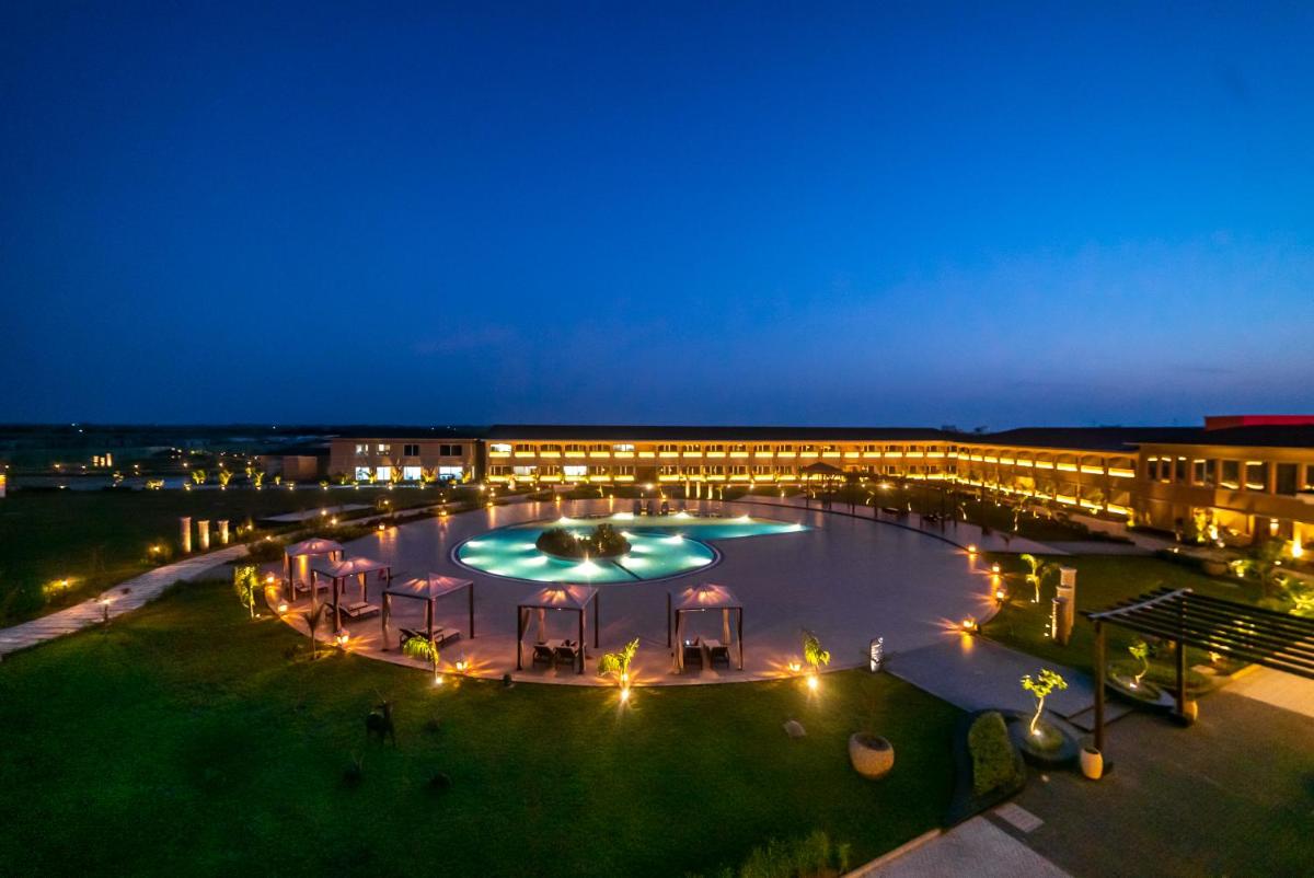 a large building with lights at night at Hawthorn Suites by Wyndham Dwarka in Dwarka a large building with lights at night at Hawthorn Suites by Wyndham Dwarka in Dwarka