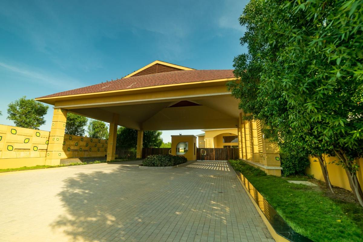 a house with a pavilion with a walkway at Hawthorn Suites by Wyndham Dwarka in Dwarka a house with a pavilion with a walkway at Hawthorn Suites by Wyndham Dwarka in Dwarka
