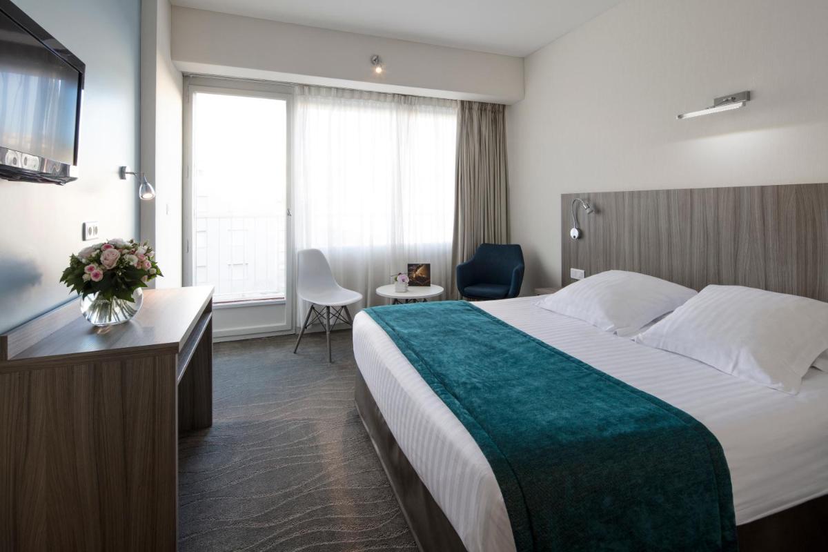 Un ou plusieurs lits dans un hébergement de l'établissement Splendid Hotel & Spa Nice
