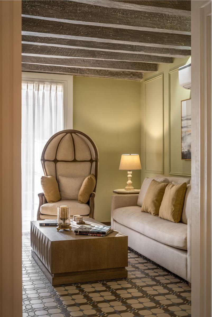 a living room with a couch and a chair at MansionHaus in Anjuna