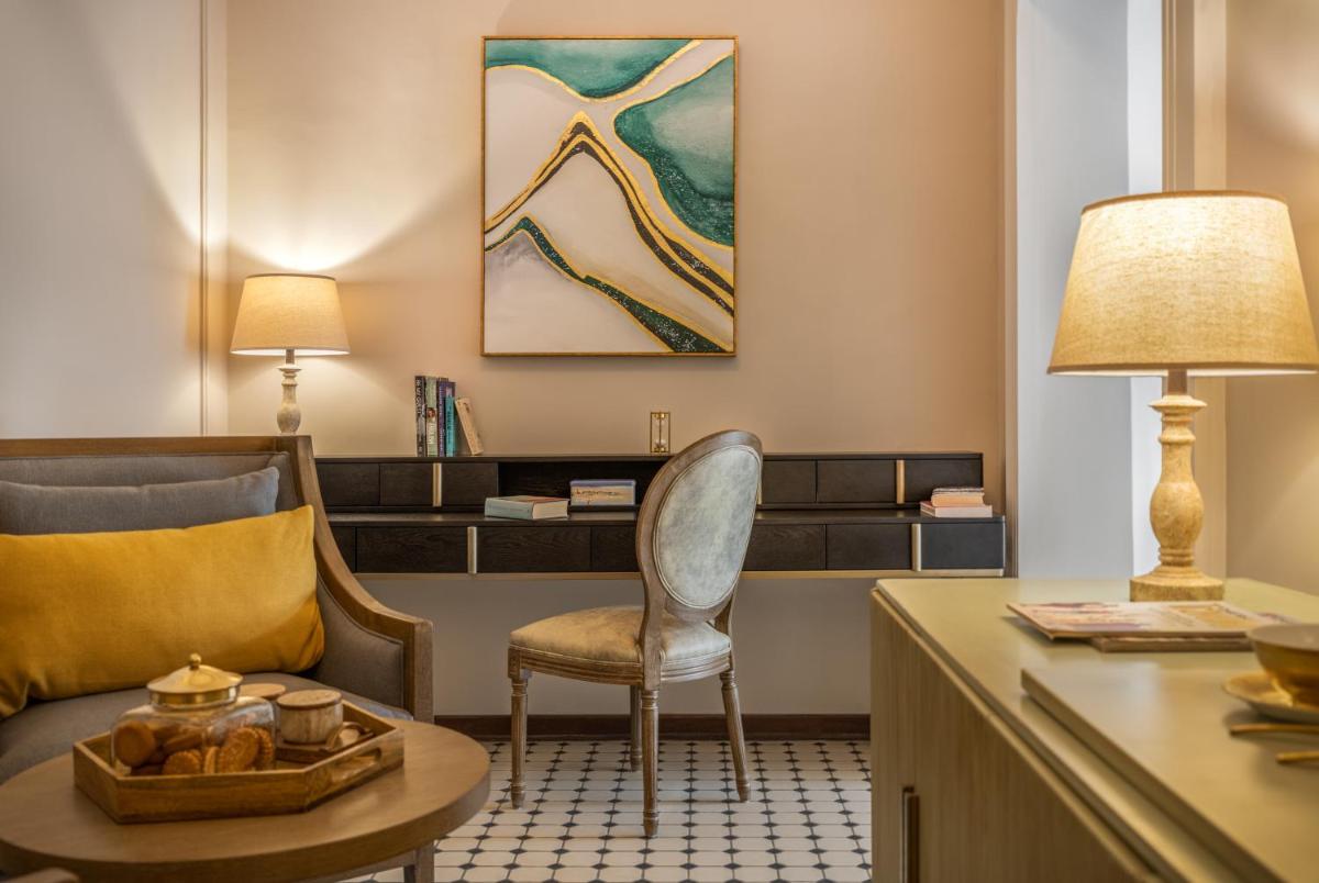 a hotel room with a desk and a chair and a table at MansionHaus in Anjuna