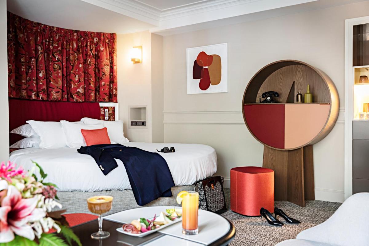 Un ou plusieurs lits dans un hébergement de l'établissement Sofitel Le Scribe Paris Opera