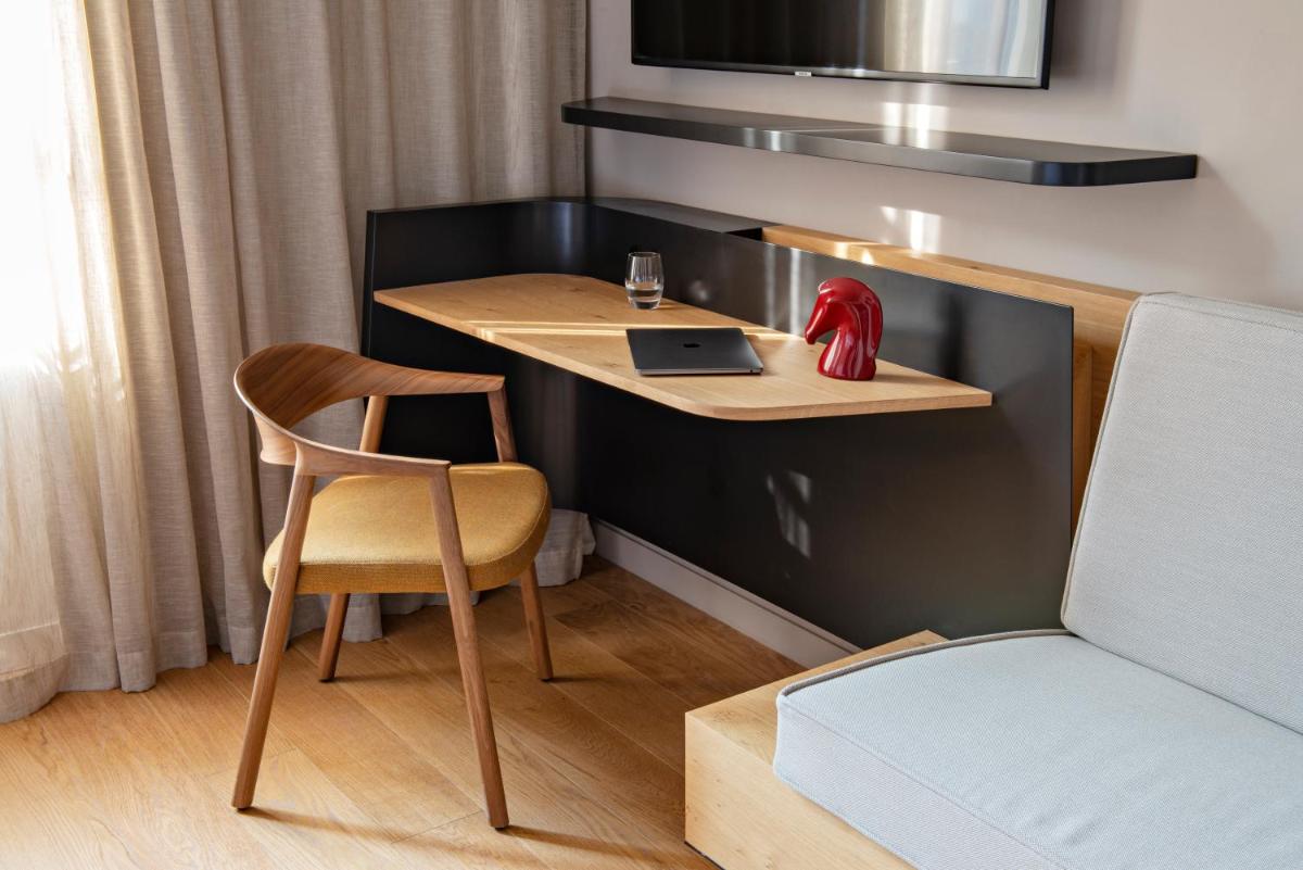 Un ou plusieurs lits dans un hébergement de l'établissement Hotel Les Haras