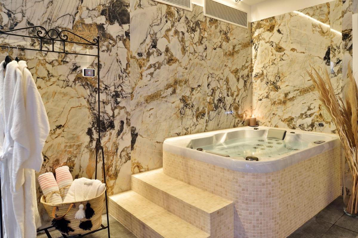 une salle de bain avec une baignoire et des escaliers dans l'établissement Hôtel Fesch & Spa, à Ajaccio