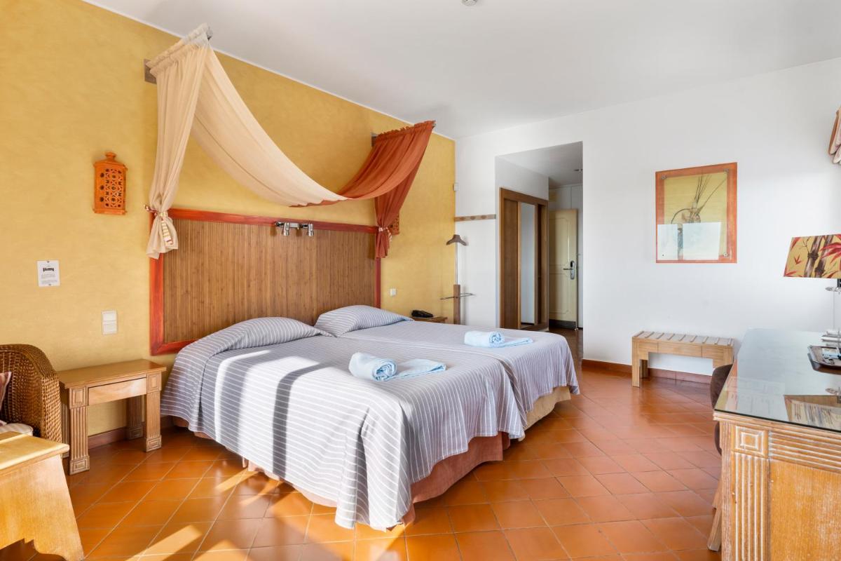 um quarto com uma grande cama branca em um quarto em Cerro Da Marina Hotel - Adults Only em Albufeira mais 31 fotografias