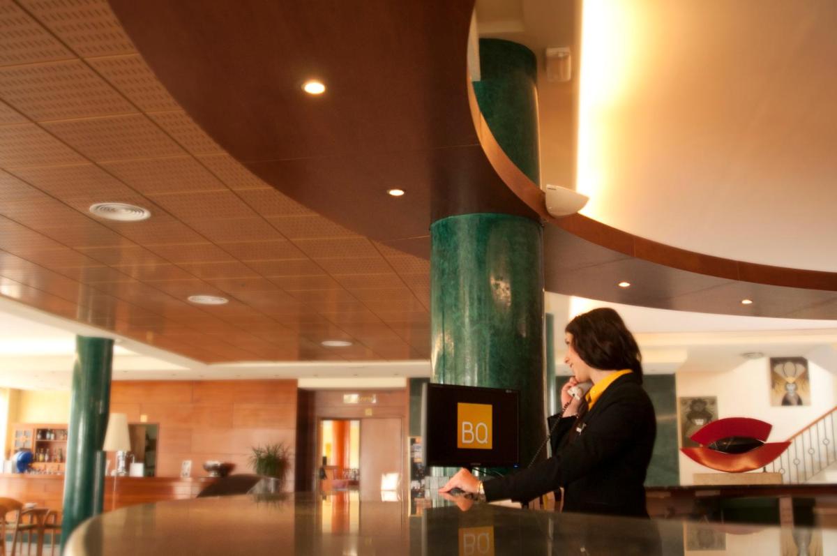 Una mujer parada en un mostrador hablando por celular en BQ Andalucia Beach Hotel, en Torre del Mar 56 fotos más