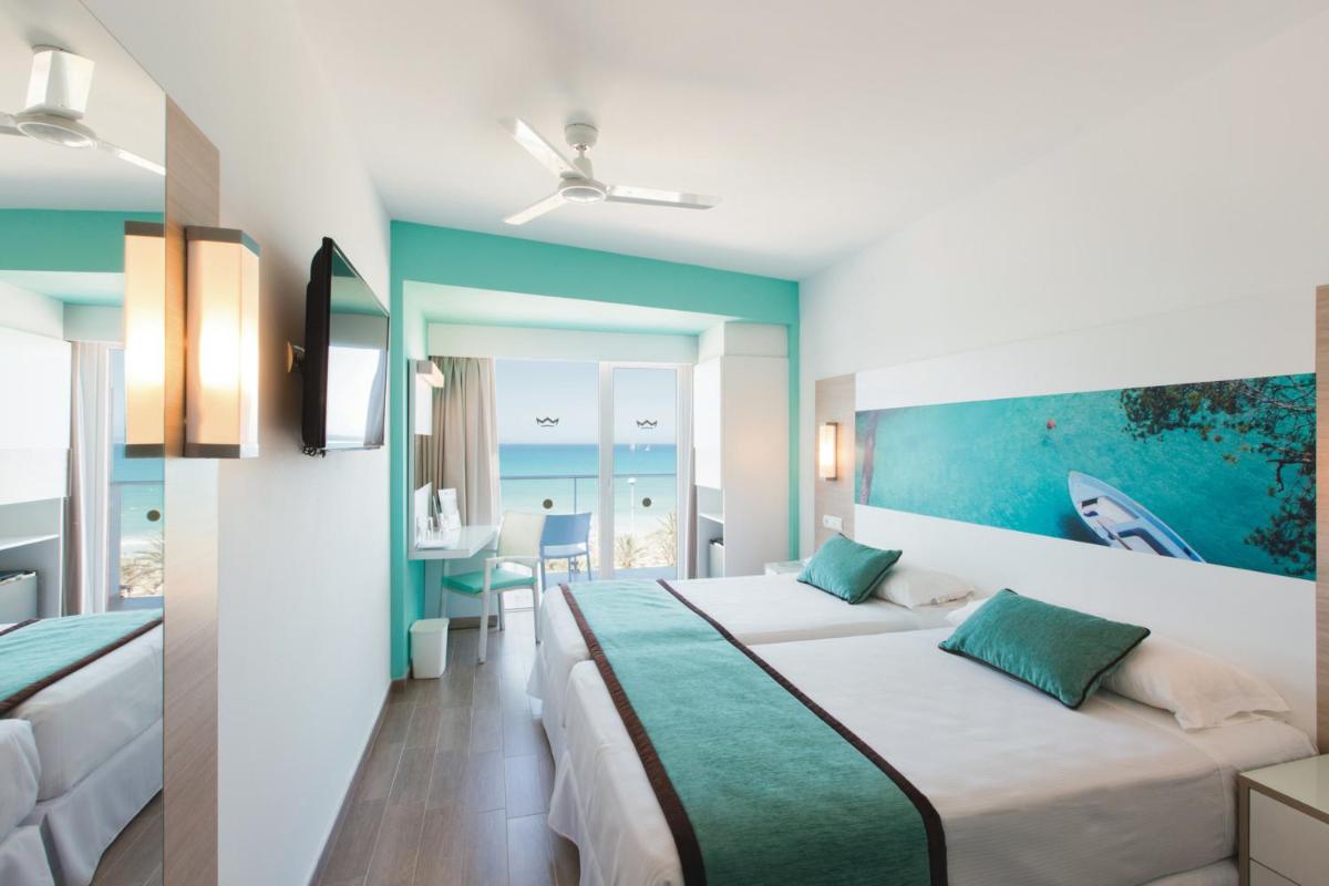una habitación de hotel con dos camas y una mesa en Hotel Riu San Francisco - Adults Only, en Playa de Palma 20 fotos más