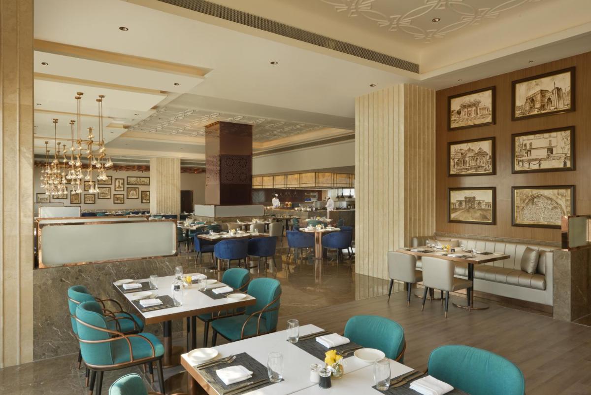 a rendering of a restaurant with tables and chairs at Taj Skyline Ahmedabad in Ahmedabad