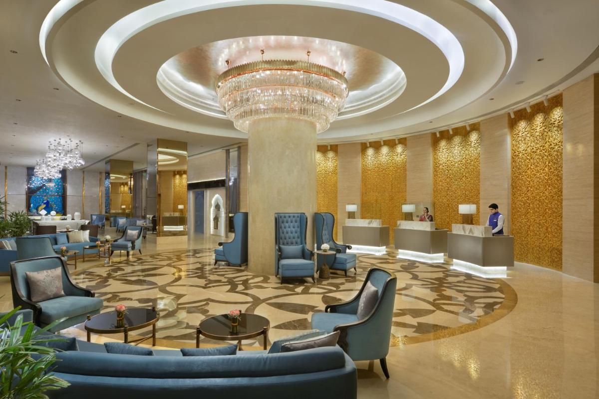 a lobby of a hotel with a large ceiling at Taj Skyline Ahmedabad in Ahmedabad