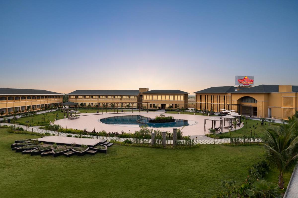 an aerial view of a resort with a pool at Hawthorn Suites by Wyndham Dwarka in Dwarka an aerial view of a resort with a pool at Hawthorn Suites by Wyndham Dwarka in Dwarka