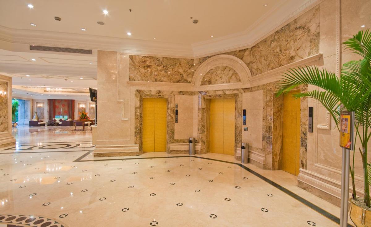 a lobby with a large room with yellow doors at The Accord Metropolitan in Chennai