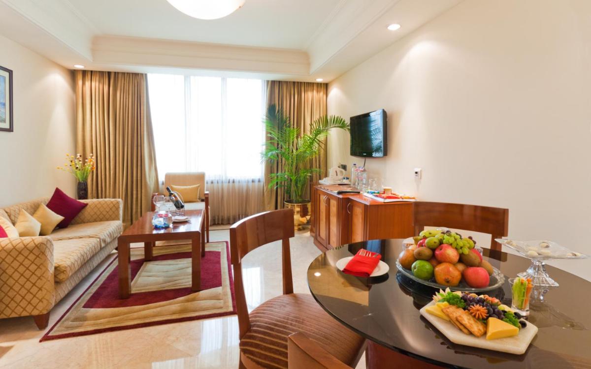 a living room with a table with a bowl of fruit at The Accord Metropolitan in Chennai