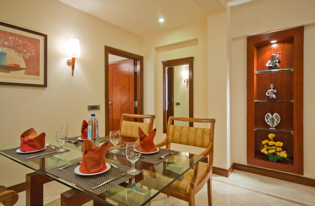 a dining room with a glass table and chairs at The Accord Metropolitan in Chennai