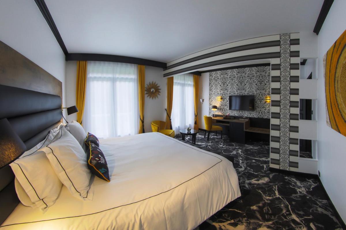 Un ou plusieurs lits dans un hébergement de l'établissement Hôtel du Barry Resort & Spa