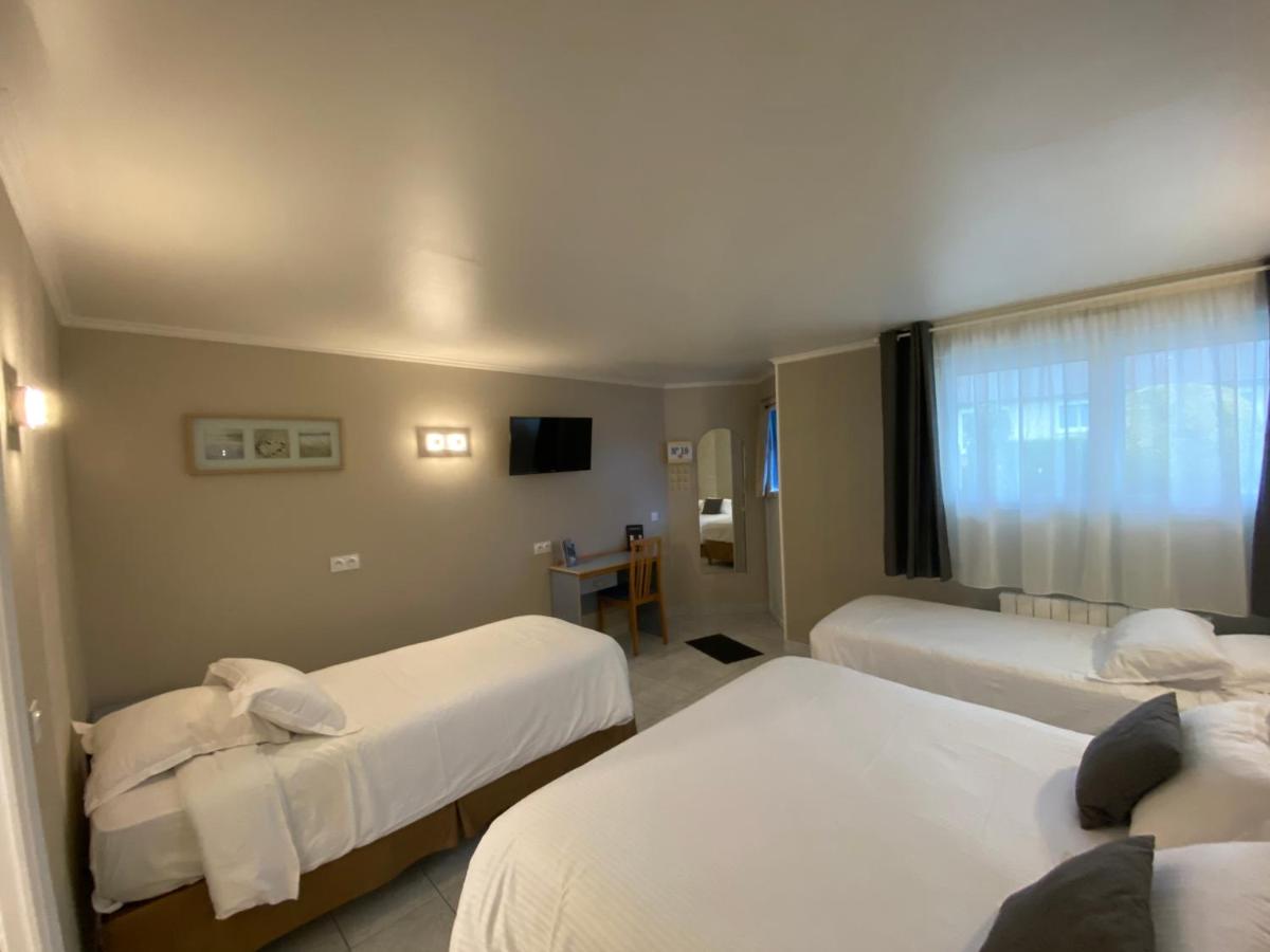 Un ou plusieurs lits dans un hébergement de l'établissement Contact hôtel - Hôtel Les Bleuets & SPA