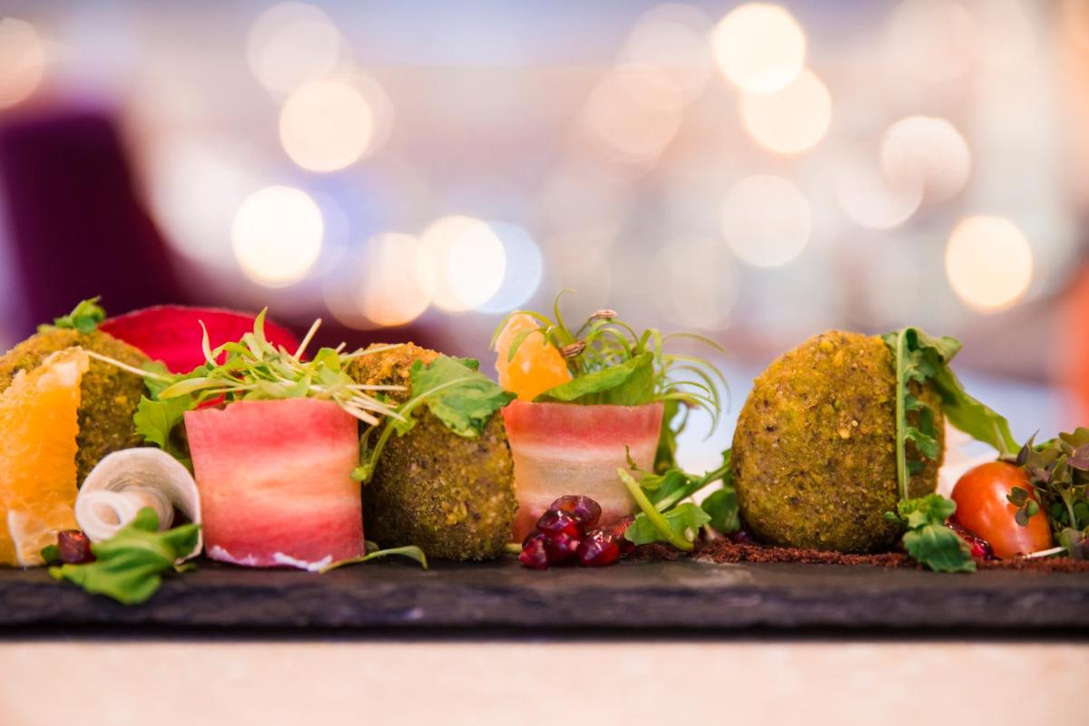 a plate with different types of food on a table at Grand Mercure Bengaluru at Gopalan Mall - An Accor Brand in Bengaluru a plate with different types of food on a table at Grand Mercure Bengaluru at Gopalan Mall - An Accor Brand in Bengaluru