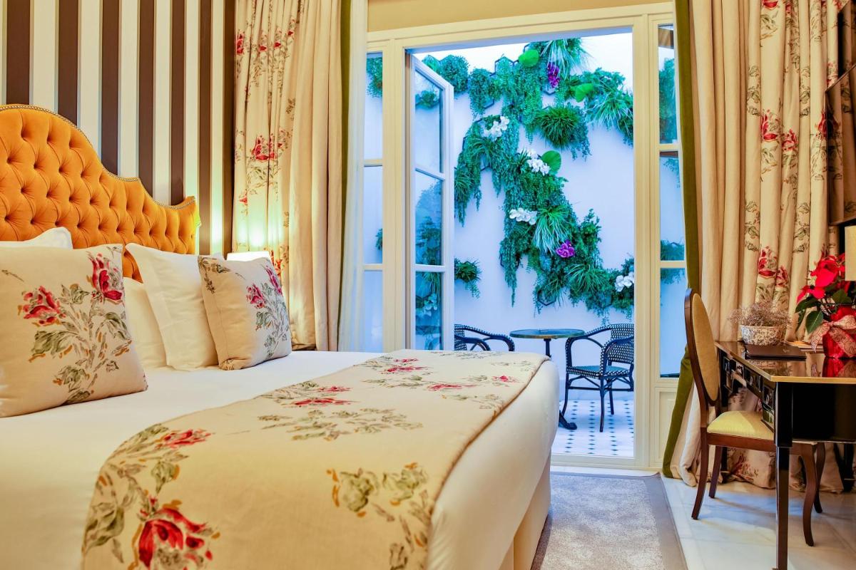 Cama o camas de una habitación en Hotel Casa Palacio María Luisa