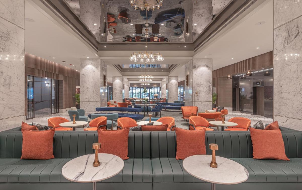 a lobby of a hotel with couches and tables at President - IHCL SeleQtions in Mumbai