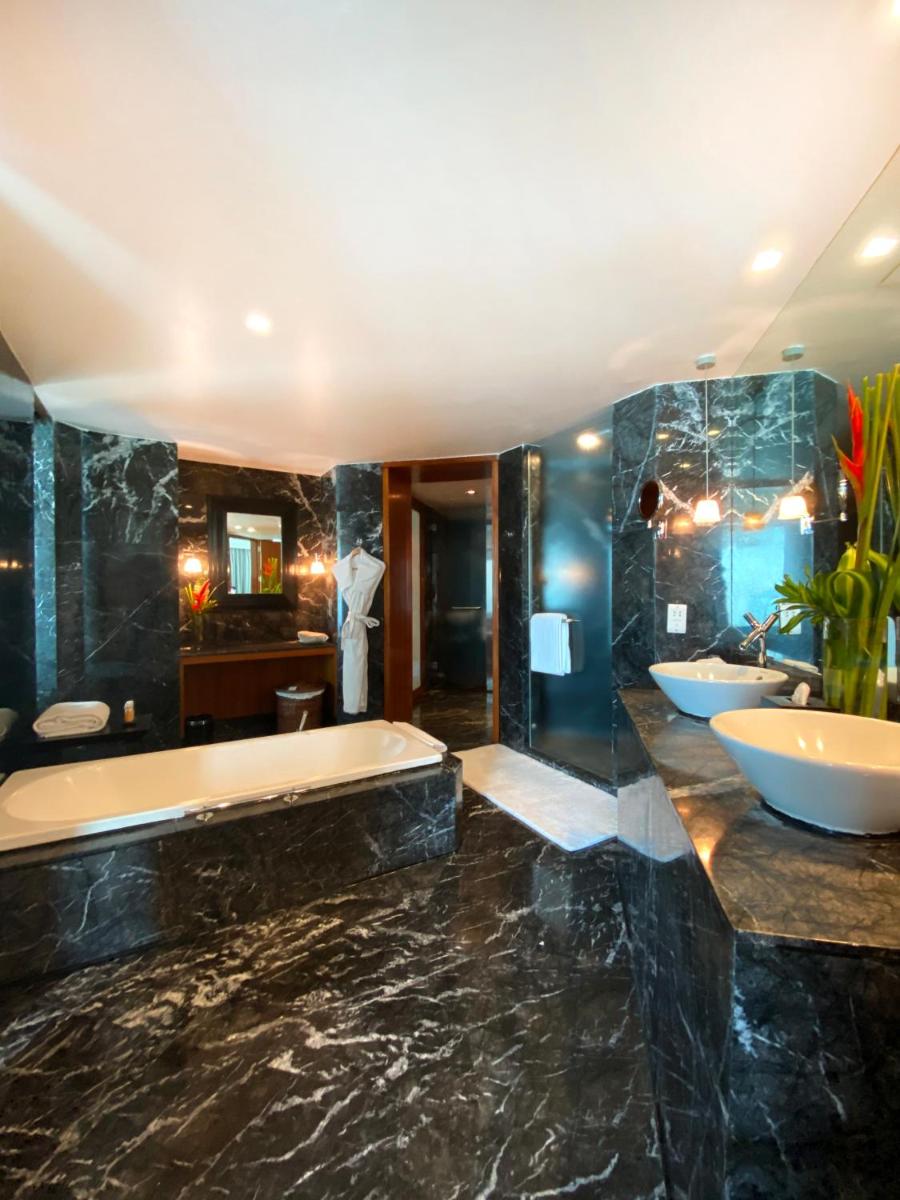 a large bathroom with two sinks and a tub at InterContinental Marine Drive Mumbai by IHG in Mumbai