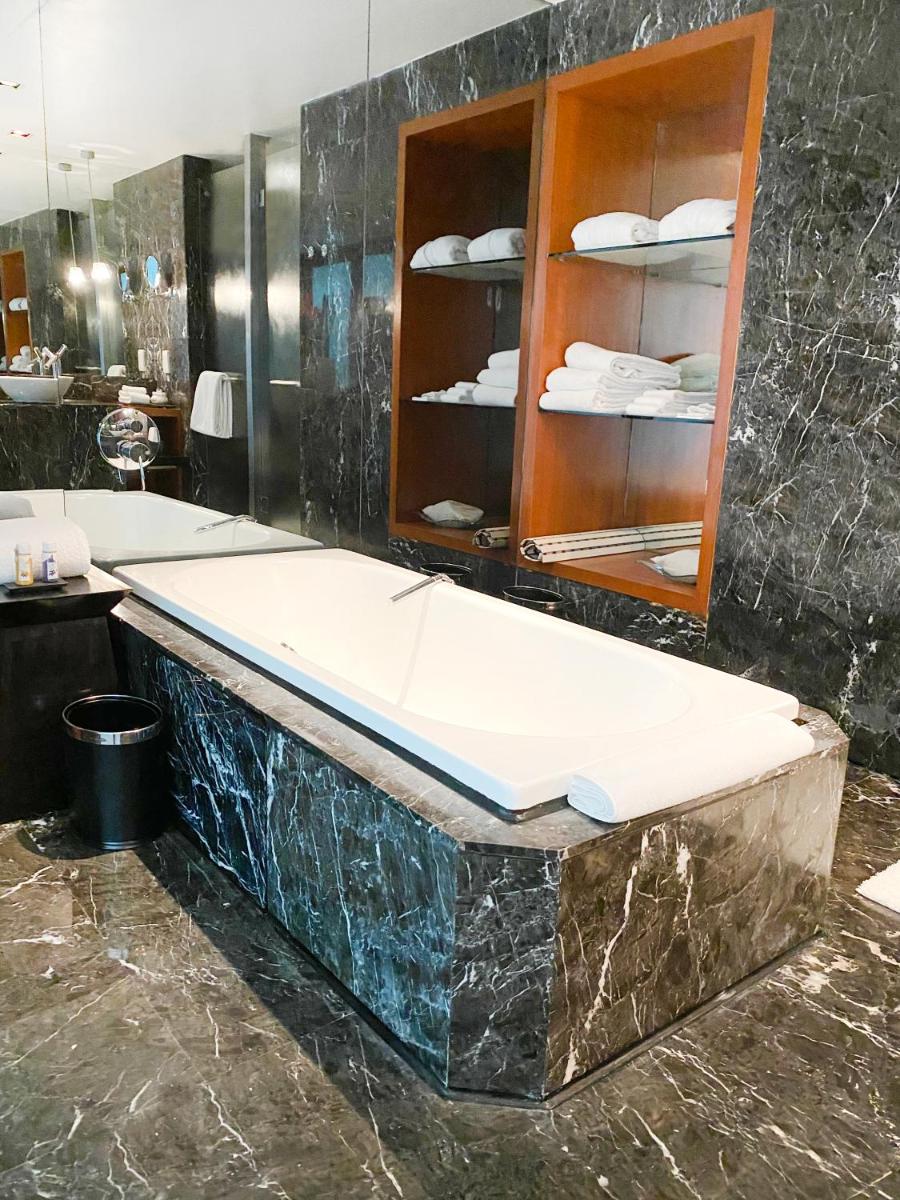 a bath tub in a bathroom with a counter at InterContinental Marine Drive Mumbai by IHG in Mumbai